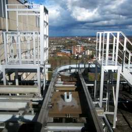 Walkway platform with drawbridge over production line Aluminium drawbridge walkway used to cross over a production line.